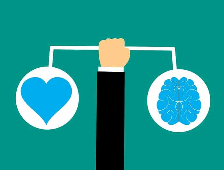 This shows a cartoon of a man holding a heart and a brain on a scale