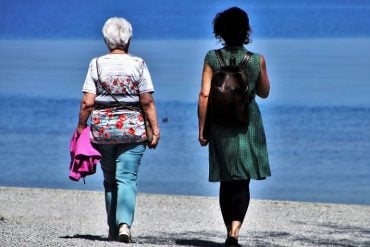 This shows two women walking on a beach
