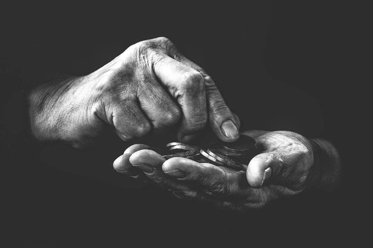 This shows coins in an older man's hands