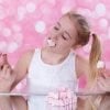 This shows a young girl eating marshmallows