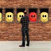 This shows a man looking at a gallery of emojis with different expressions