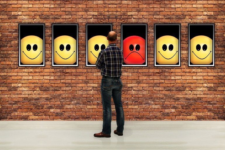 This shows a man looking at a gallery of emojis with different expressions