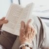 This shows an elderly woman reading a book