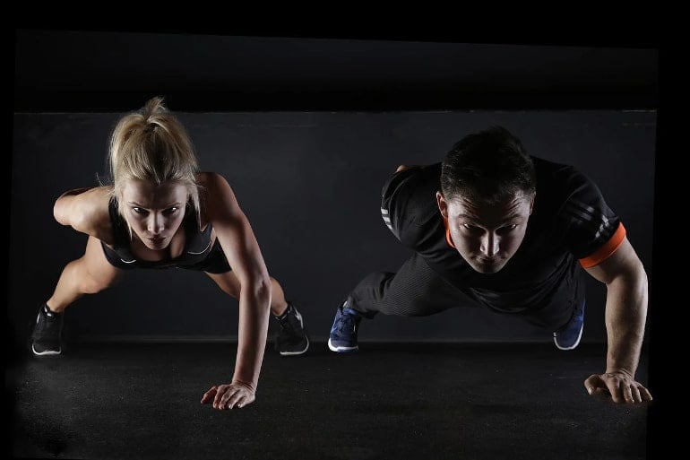 This shows a man and woman doing pushups