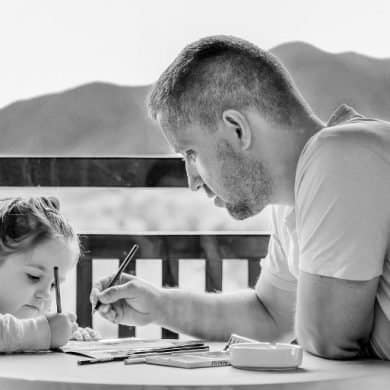 This shows a dad helping his daughter with homework