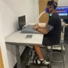 This shows a test subject sitting at a table and using a foot cycle