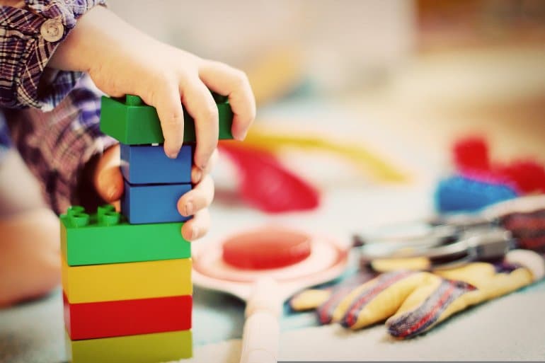 this shows a child playing with blocks