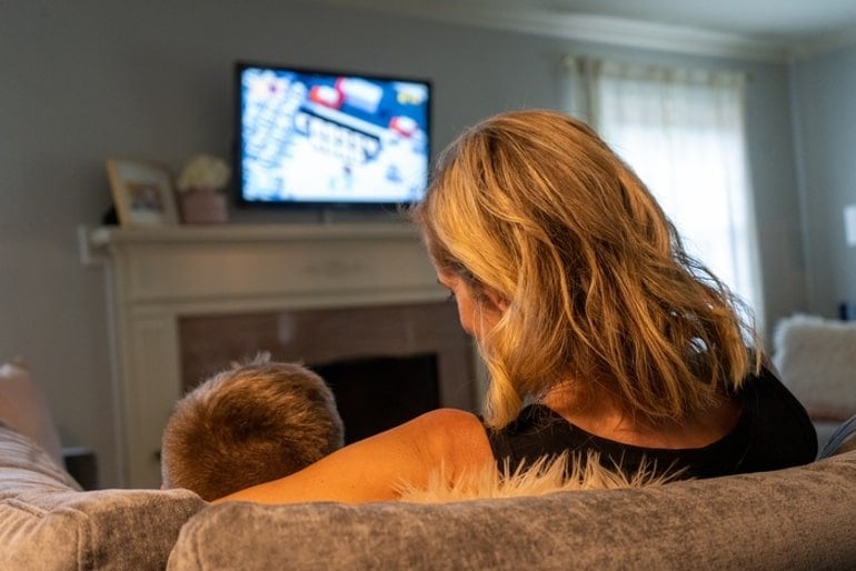 This shows a mom and son watching tv