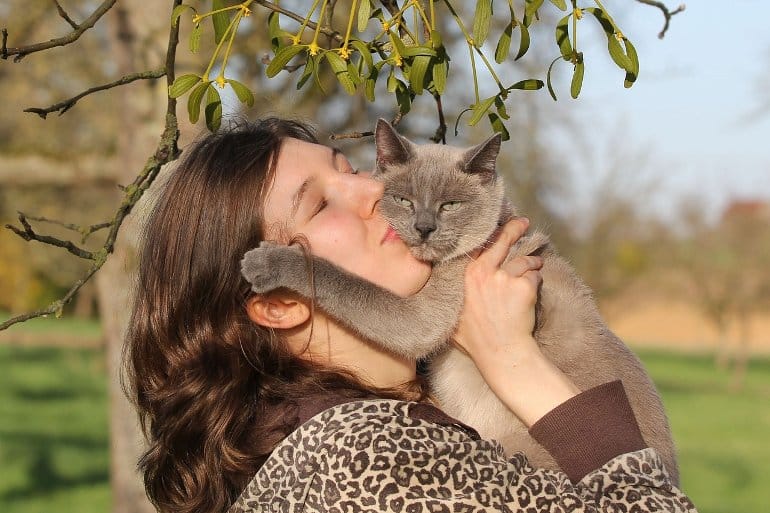 This shows a lady holding her cat