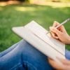 This shows a woman writing in a journal