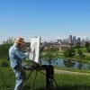 This shows an older man painting
