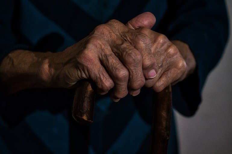 This shows an older person's hands