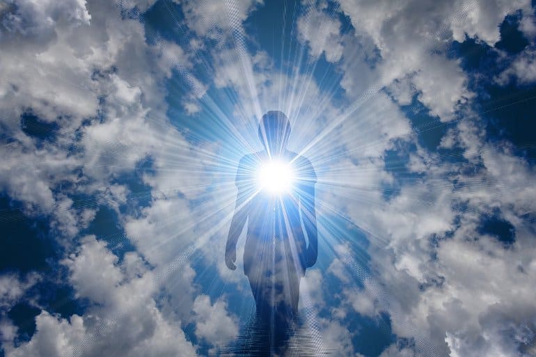It shows the outline of a man surrounded by clouds and light
