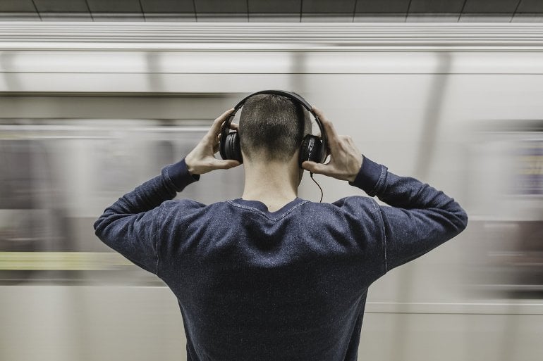 This shows a person listening to music on headphones