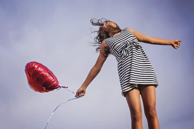 This shows a woman holding a balloon