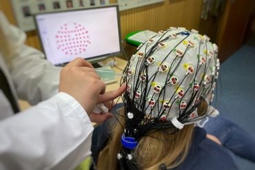 This shows a woman in an EEG cap