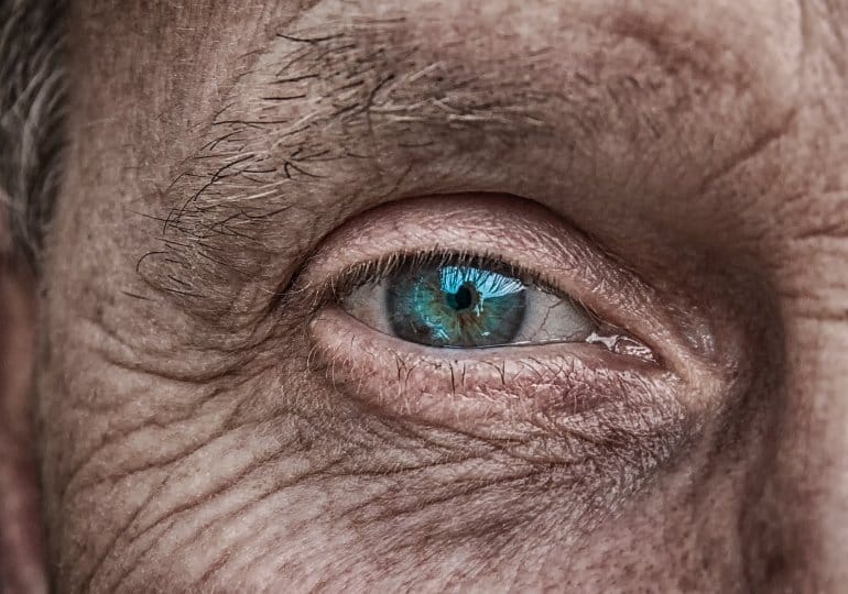 It shows an older man's eye