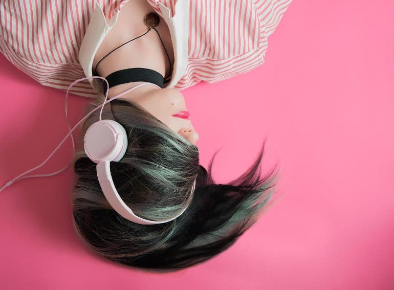This shows a woman listening to music on headphones
