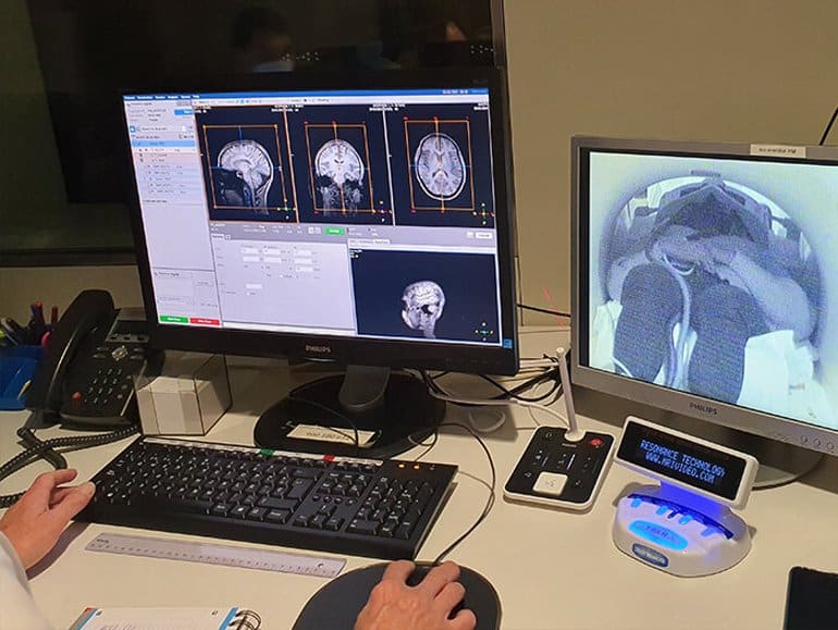 This shows a researcher looking at brain scans on a computer