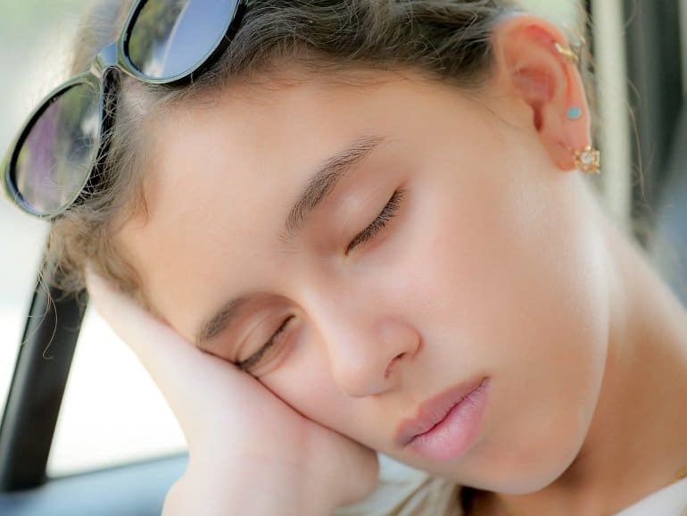 This shows a sleeping teen girl