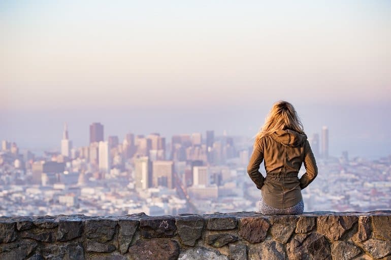 This shows a woman looking out over a city