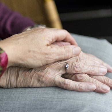 This shows an older woman's hands