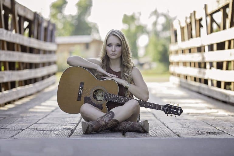 This shows a woman with a guitar