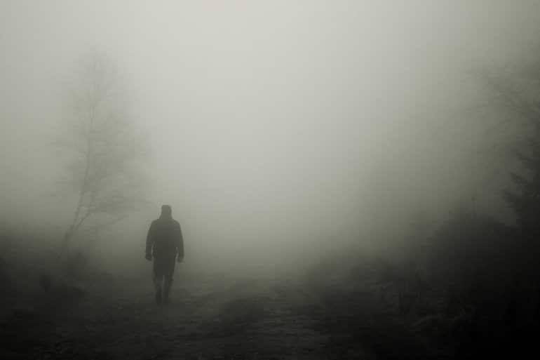 This shows a man walking in fog