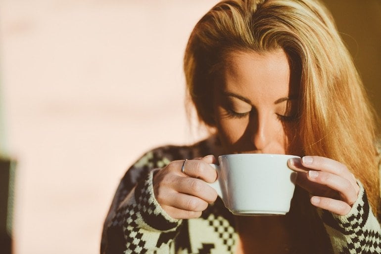 This shows a woman drinking coffee