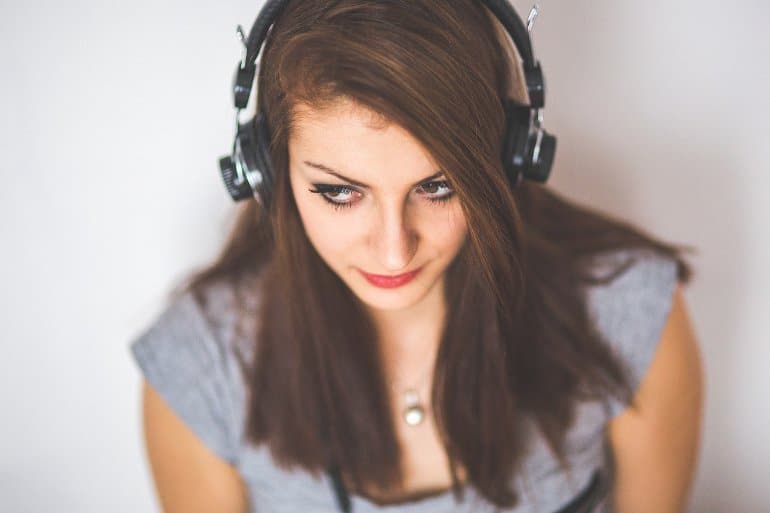 This shows a woman listening to music on headphones