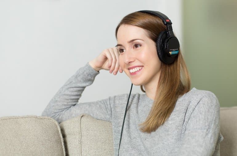 This shows a woman listening to music on headphones