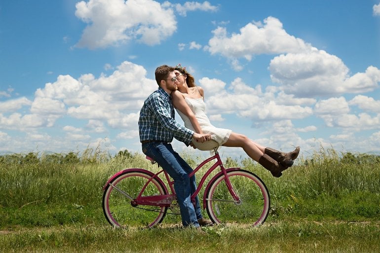 This shows a couple on a bike