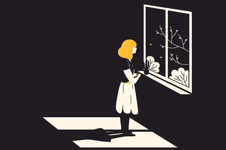 This shows a woman standing alone by a window