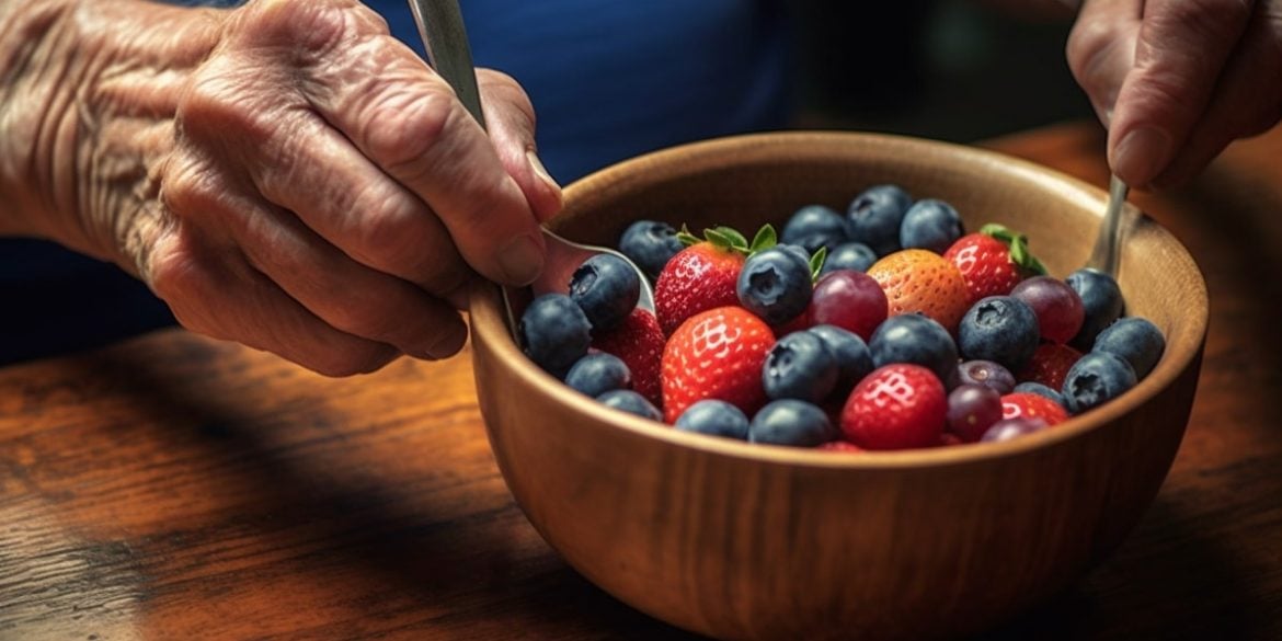 This shows a person eating a berry fruit salad.