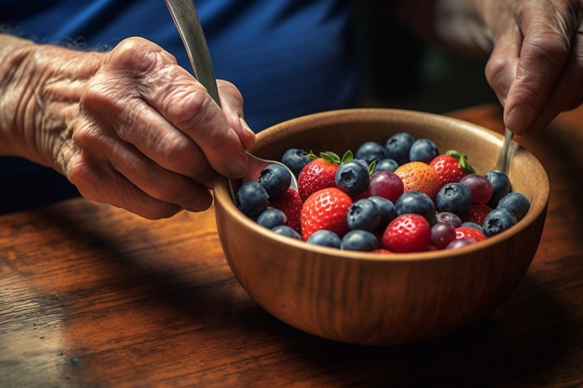 This shows a person eating a berry fruit salad.