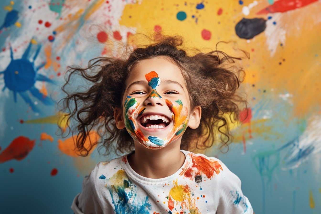 This shows a happy child covered in paint.