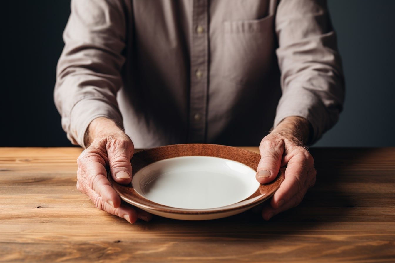 This shows a dinner plate and a man's hands.