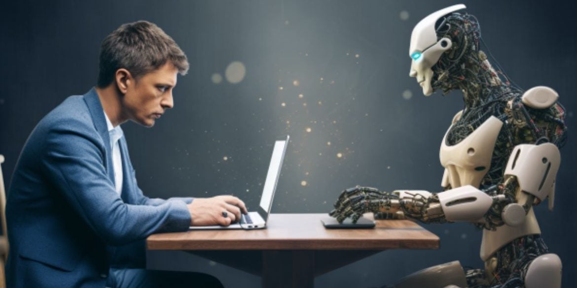 This shows a man on a laptop and a robot.