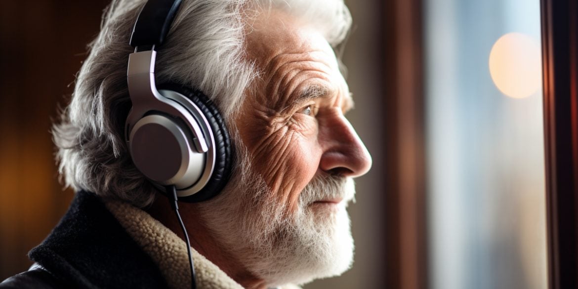 This shows an older man listening to music.