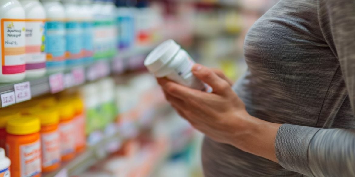 This shows a pregnant woman looking at pills.