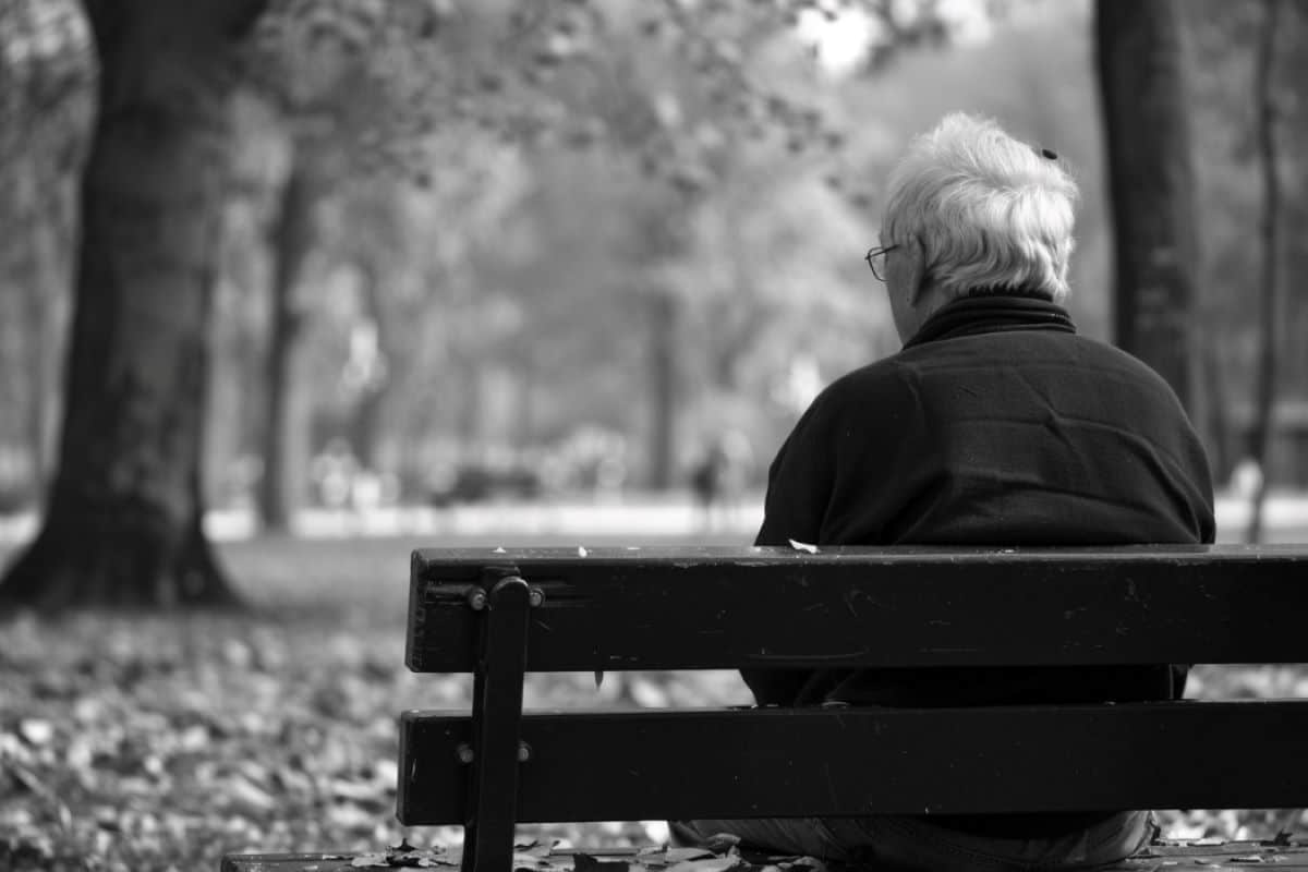 This shows a man sitting alone on a bench.