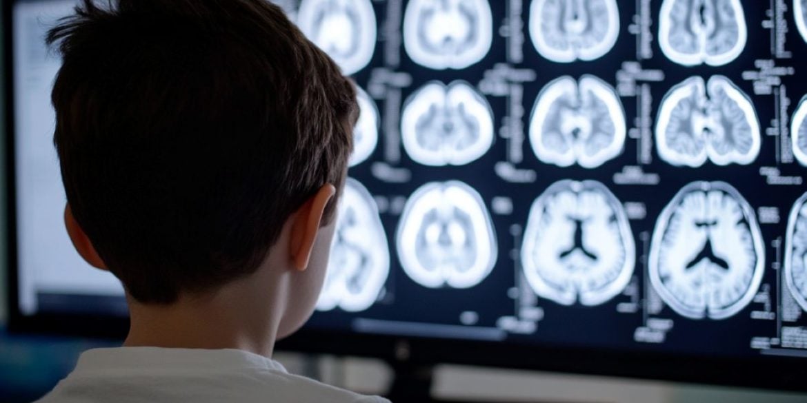 This shows a child looking at brain scans.