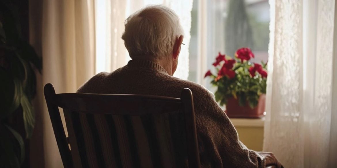 This shows an older man sitting alone.