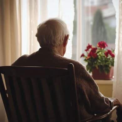 This shows an older man sitting alone.