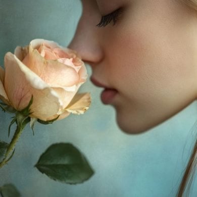 This shows a woman smelling a rose.