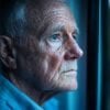 This shows an older man looking out a window.