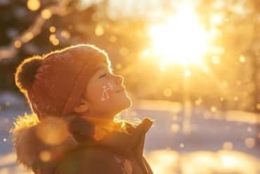 This shows a child standing in the sunshine.