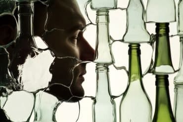 This shows a man's face and broken bottles.