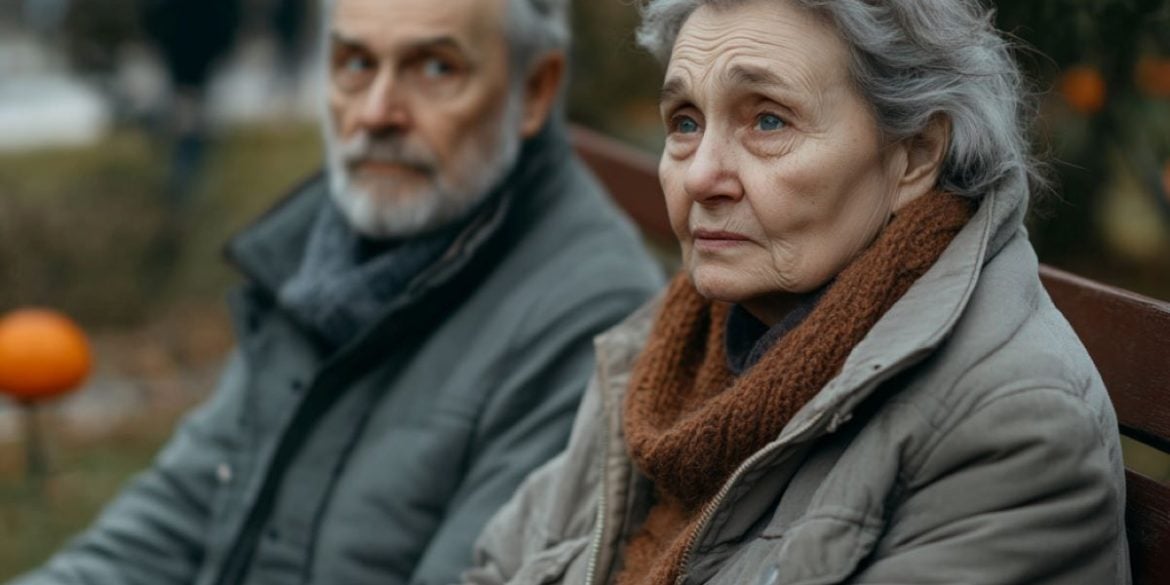 This shows an older couple sitting on a bench.