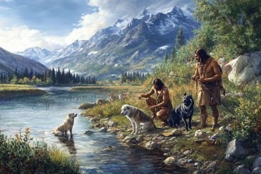 This shows ancient man fishing with dogs at his side.